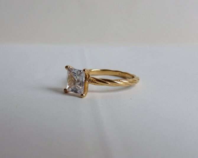 Gold-plated engagement band in real zirconia setting all around