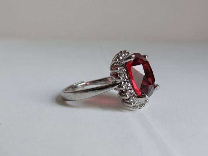 Rhodium-plated alloy ring with zirconia and crystalline garnet big stone