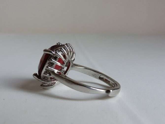 Rhodium-plated alloy ring with zirconia and crystalline garnet big stone